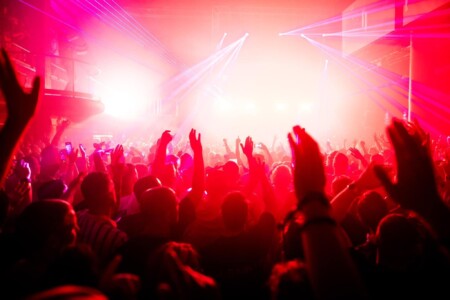 photo of a crowd lit up by red stage lights